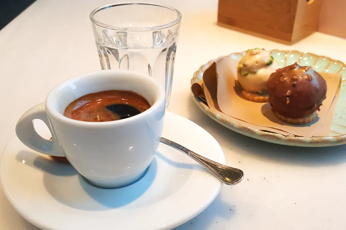 Espresso-served-with-a-glass-of-water-and-two-chocolate-sweets-Vicenza-Italy-rossiwrites.com-2.jpg